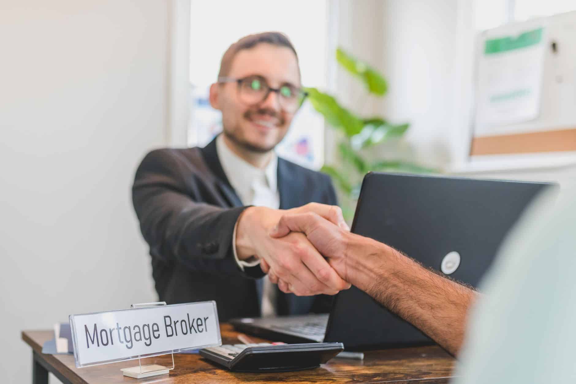 Small business website advice Tradesman handing a business card to a customer to get more referrals
