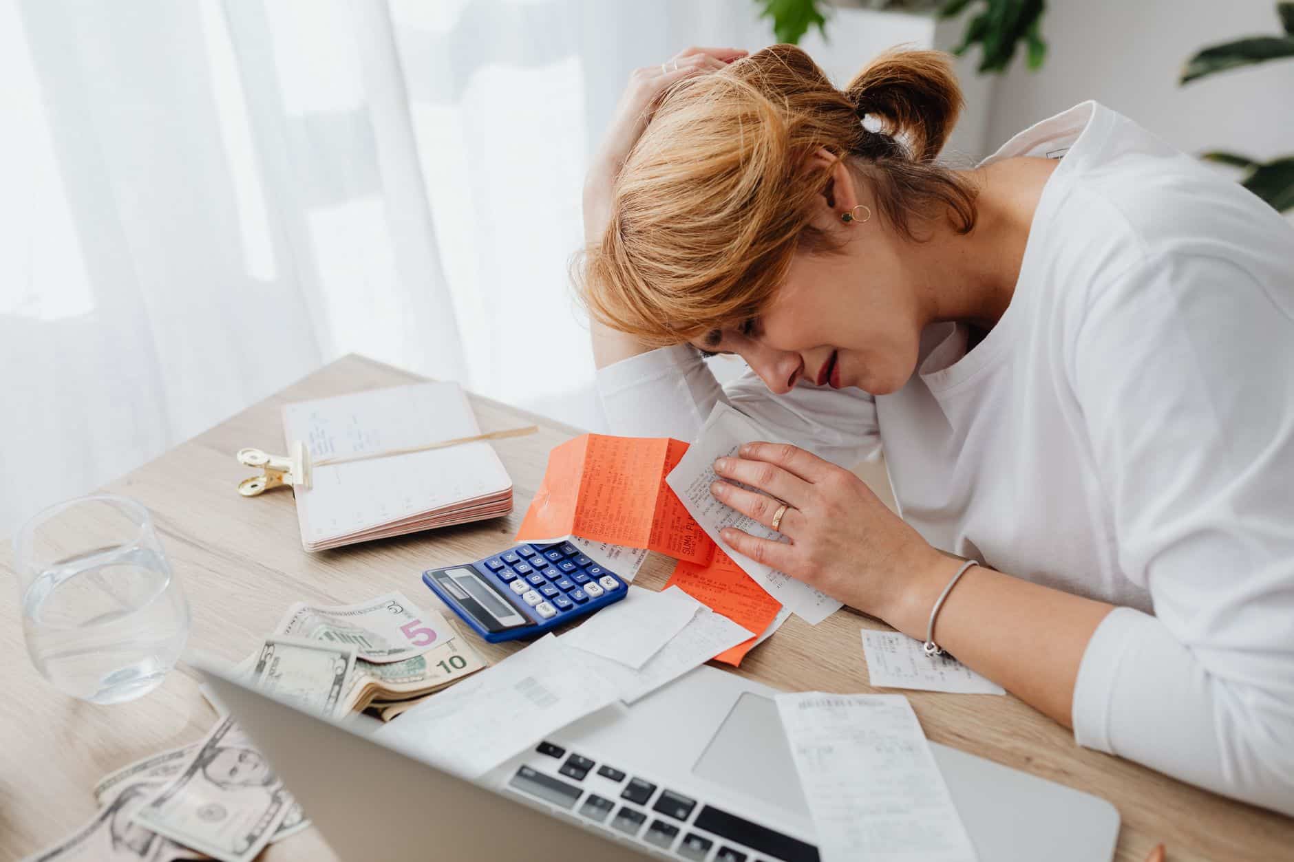Small business website advice Sole trader doing business record keeping with receipts and a notebook at a kitchen table