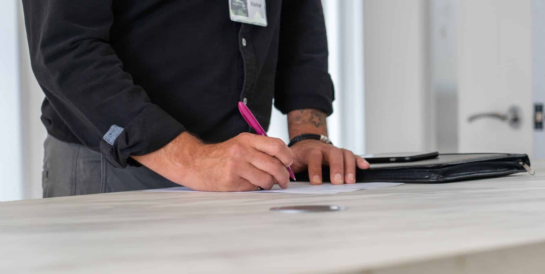 Small business website advice Small business owner comparing limited company and sole trader paperwork at a kitchen table